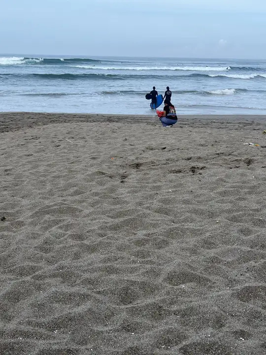 Taking an offering down to the water's edge.
